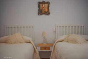 A bed or beds in a room at Santa Angela de la Cruz