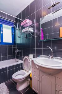 a bathroom with a toilet and a sink at Villa Sea-N-Sun, 7 bedrooms & Pool, nearby Portonovi Marina. in Ðenovići