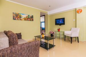 a living room with a couch and a table at Villa Sea-N-Sun, 7 bedrooms & Pool, nearby Portonovi Marina. in Ðenovići