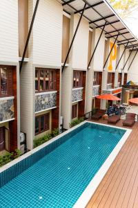 a swimming pool in front of a building at P Chaweng in Chaweng