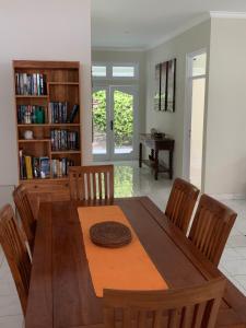 a dining room with a wooden table and chairs at Alinta Villa 1 in Sanur