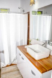 a bathroom with a white sink and a mirror at Hostel Mar y Campo in Piriápolis