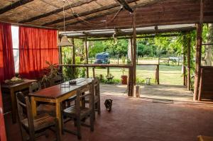 a dining room with a table and a view of a yard at Hostel Mar y Campo in Piriápolis