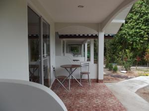 a patio with a table and chairs on a house at Real Relax Resort in Ao Nang Beach