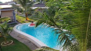 a swimming pool in a yard with a palm tree at Positano Alona Beach Panglao in Panglao