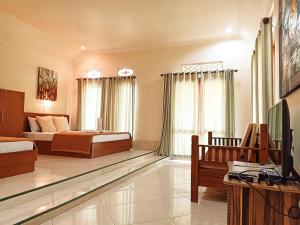 a bedroom with a bed and a tv in a room at Two Brothers Bungalows in Gili Meno