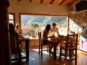 a group of people sitting at a table at Hosteria La Pushka in Purmamarca