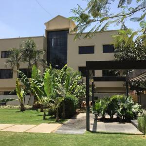 a building with a bunch of plants in front of it at Liva Rooms in Nashik