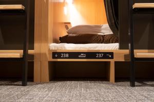 Letto o letti in una camera di WeBase Hiroshima