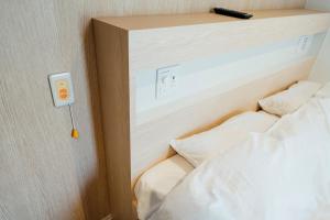 Letto o letti in una camera di WeBase Hiroshima