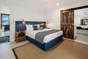 a bedroom with a large bed and a large window at Freedom Shores in Cannon Valley