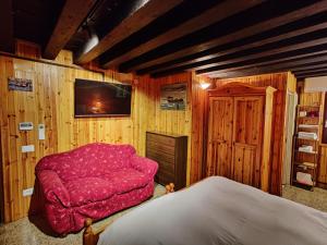 a bedroom with a red chair and a bed at La casa del pescatore: a lovely escape in Venice!! in Venice