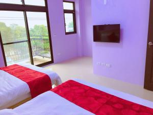 1 Schlafzimmer mit 2 Betten und einem Flachbild-TV in der Unterkunft Yun Shan Shuei Country House in Fengping
