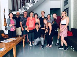 a group of people posing for a picture in a living room at Mr Rot's Secret Hotel in Da Lat