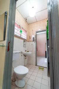 a bathroom with a toilet and a sink and a shower at Star Light Homestay in Sitiawan