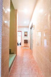 a hallway of a bathroom with a shower and a toilet at Star Light Homestay in Sitiawan