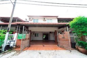 a house with a gate in front of it at Star Light Homestay in Sitiawan