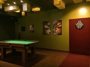 a room with a pool table and paintings on the wall at Mosaic City Hotel in Madaba