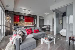 a living room with a gray couch and red pillows at Luxury Adventure CN Tower/MTCC/Scotiabank Arena in Toronto