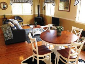 a living room with a table and chairs and a couch at Milford Country Cottages in Milford