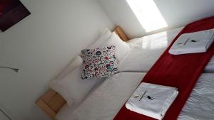 a bedroom with two beds with white sheets and pillows at Nádirigó Apartman Balatonberény in Balatonberény +14 photos