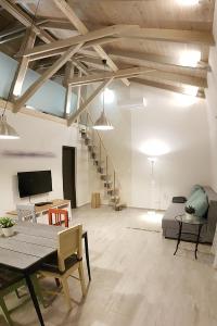 a large living room with a table and a couch at Nádirigó Apartman Balatonberény in Balatonberény