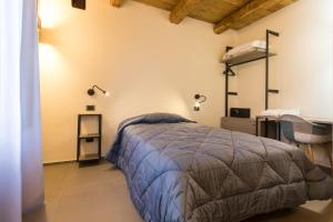 Uma cama ou camas num quarto em Borgotufi Albergo Diffuso