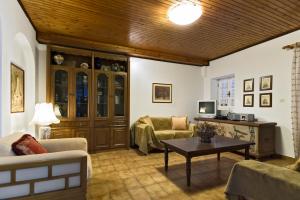 a living room with a couch and a table at Villa Bacchus Kassiopi Corfu in Kassiopi