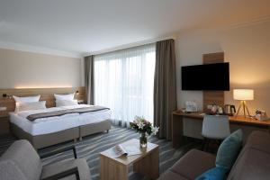 Ein Bett oder Betten in einem Zimmer der Unterkunft Quality Hotel Lippstadt