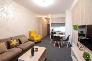 a living room with a couch and a table at Apartment Marco Hrebienok in Smokovce