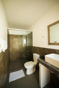 a bathroom with a toilet and a sink and a shower at Bali Villas Panglao Bohol in Panglao Island