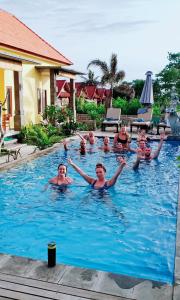 a group of people in a swimming pool at Dream Beach Hostel Lembongan in Nusa Lembongan