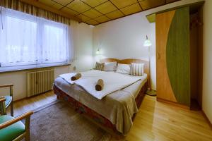 a bedroom with a large bed and a large window at Waldhotel Rennsteighöhe in Frauenwald