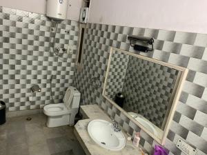 a bathroom with a toilet and a sink at The Desire Hostel in New Delhi