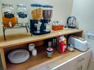 a wooden shelf with some food items on it at The Desire Hostel in New Delhi