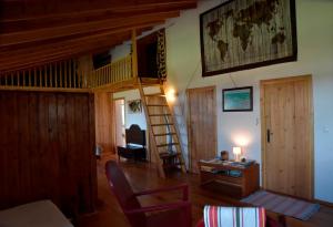 a living room with a loft bed and a desk at Caldeira Guesthouse in Fajã da Caldeira de Santo Cristo