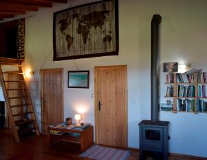 a room with a wood stove and a door at Caldeira Guesthouse in Fajã da Caldeira de Santo Cristo