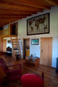 a living room with a large map on the wall at Caldeira Guesthouse in Fajã da Caldeira de Santo Cristo