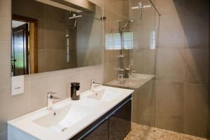 a bathroom with two sinks and a shower at Beausoleil in Bonnievale