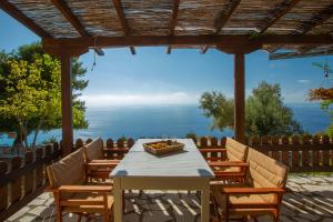 a table and chairs with a view of the ocean at anerada / sun nature holidays in Athanion