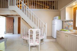 a kitchen with two chairs and a staircase at anerada / sun nature holidays in Athanion