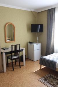 a hotel room with a desk and a bed and a chair at Hotel Vyrubovo in Odintsovo
