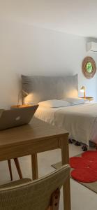 a bedroom with a bed and a laptop on a table at 7 Hotel Particulier in Agen