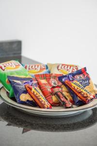 a plate of candy bars and chips on a table at Funkey Villas Cape Town in Cape Town