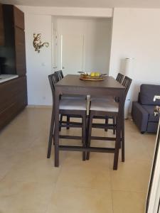 a dining room table and chairs in a living room at Exclusive Apartment - Playa de Marenys de Rafalcaid in Gandía