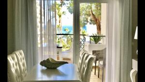 a table with a hat on it in front of a window at MI CAPRICHO 9B BEACHFRONT- Apartment with sea view - Costa del Sol in Mijas Costa