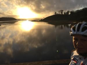 a man wearing a helmet next to a body of water at Paradise Found in Knysna