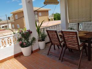 a patio with two chairs and a table on a balcony at Exclusive Apartment - Playa de Marenys de Rafalcaid in Gandía