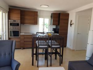 a kitchen with a table and chairs in a room at Exclusive Apartment - Playa de Marenys de Rafalcaid in Gandía