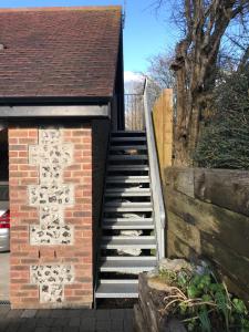 a set of stairs leading up to a house at Hunters Hide Apt in Littlehampton